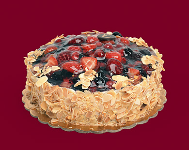Fruit cake with vanilla cream and chopped almonds